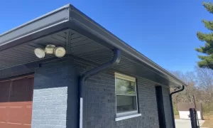 residential gutter (aluminum grey) installation on a grey brick home in Cincinnati 